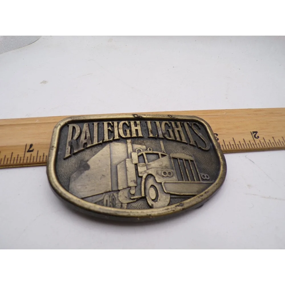 Vintage Raleigh Lights Semi Truck Belt Buckle Brass Tone Tobacco Advertising